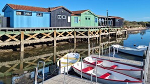 A dock with colorful wooden buildings and boats.