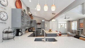 A modern kitchen with a central island, stainless steel appliances, and pendant lighting. - 500 FT To Beach, Main House, Guest House, Fire Pit (Union Pier)