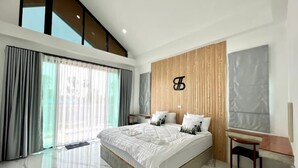 A modern bedroom with a large bed, a desk, and a view of the outdoors. - The Estretto Resort (Wiang Chiang Rung)