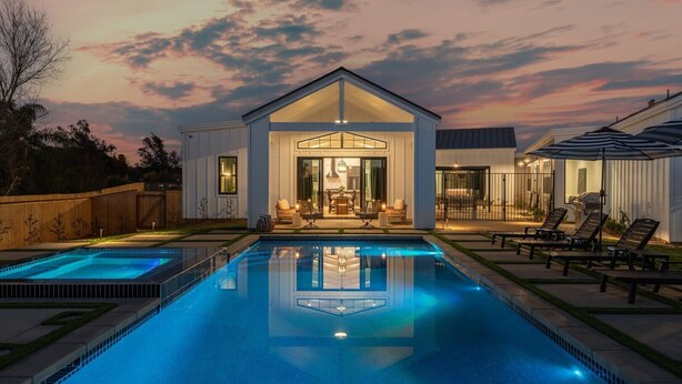 A modern house with a swimming pool, outdoor seating, and a patio area. - Vintner's Village | California-Chic Wine Estate (Temecula)
