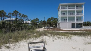 A beach with a wooden bench labeled "S NEPTUNE MICHAEL 10-10-18". - RV LOT Pole barn is fully covered and concreted Indian Pass (Port Saint Joe)