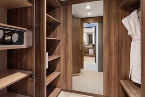 A walk-in closet with wooden shelving and a microwave. - Meliá Düsseldorf (Düsseldorf)