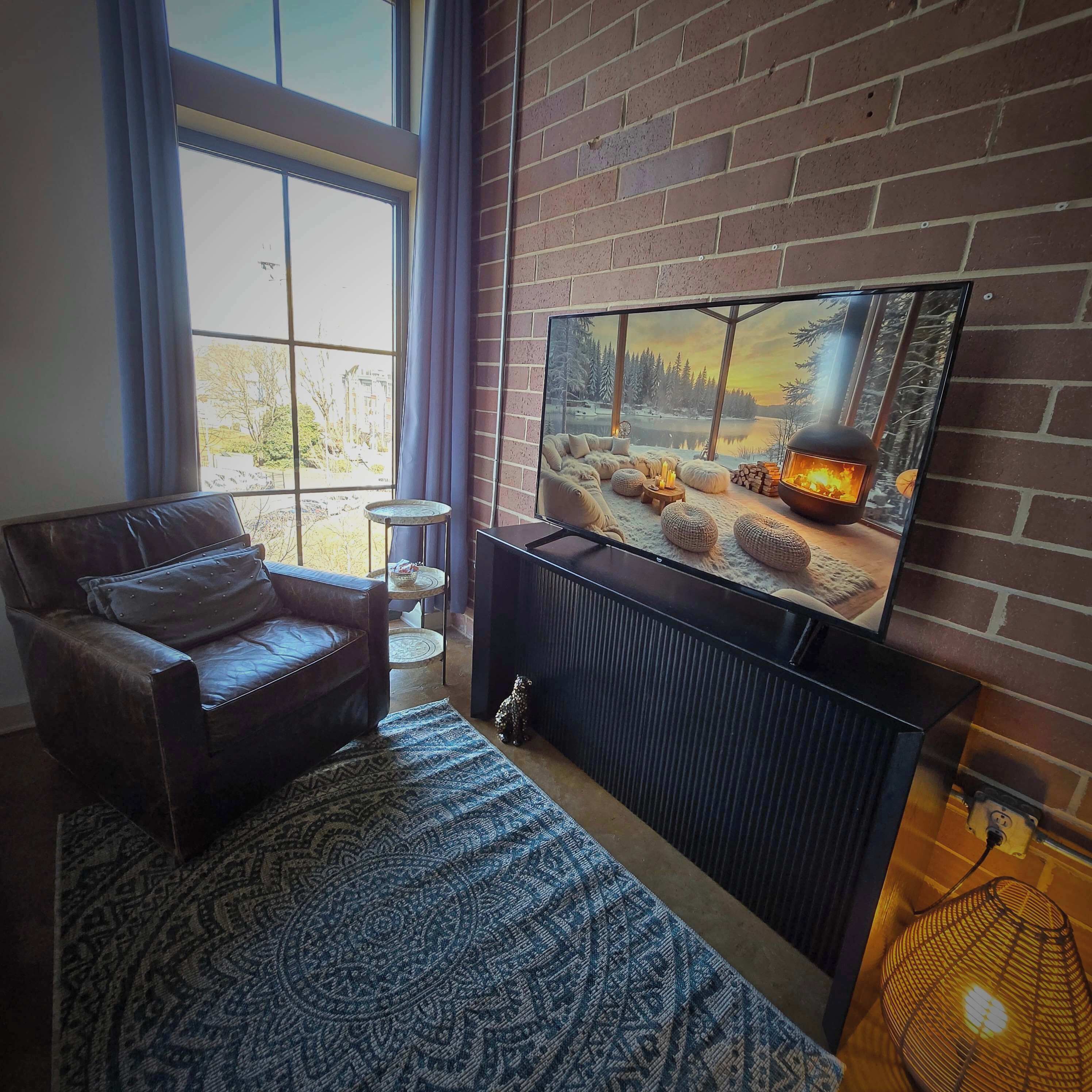A living room with a fireplace, a television, and a sofa.