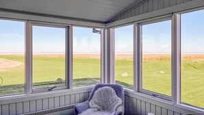 A room with large windows offering a view of a grassy field and a distant shoreline. - 2 bedroom stunning home in Vinderup (Vinderup)