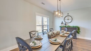 A dining room with a wooden table set for six, surrounded by dark chairs. - 7 Mi to Talladega Superspeedway: Home w/ Lake View (Lincoln)