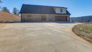 A two-story house with a garage, a driveway, and a lake view. - 7 Mi to Talladega Superspeedway: Home w/ Lake View (Lincoln)