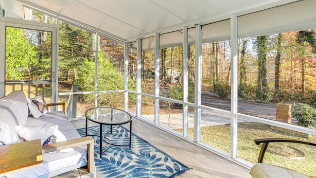 A covered porch with a sofa, a glass table, and a patterned rug. - 1 Mi to Stone Mountain Park: Outdoor Haven! (Stone Mountain)