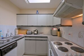 Enjoy cooking in this well-equipped kitchen with a stovetop, dishwasher, and sink.