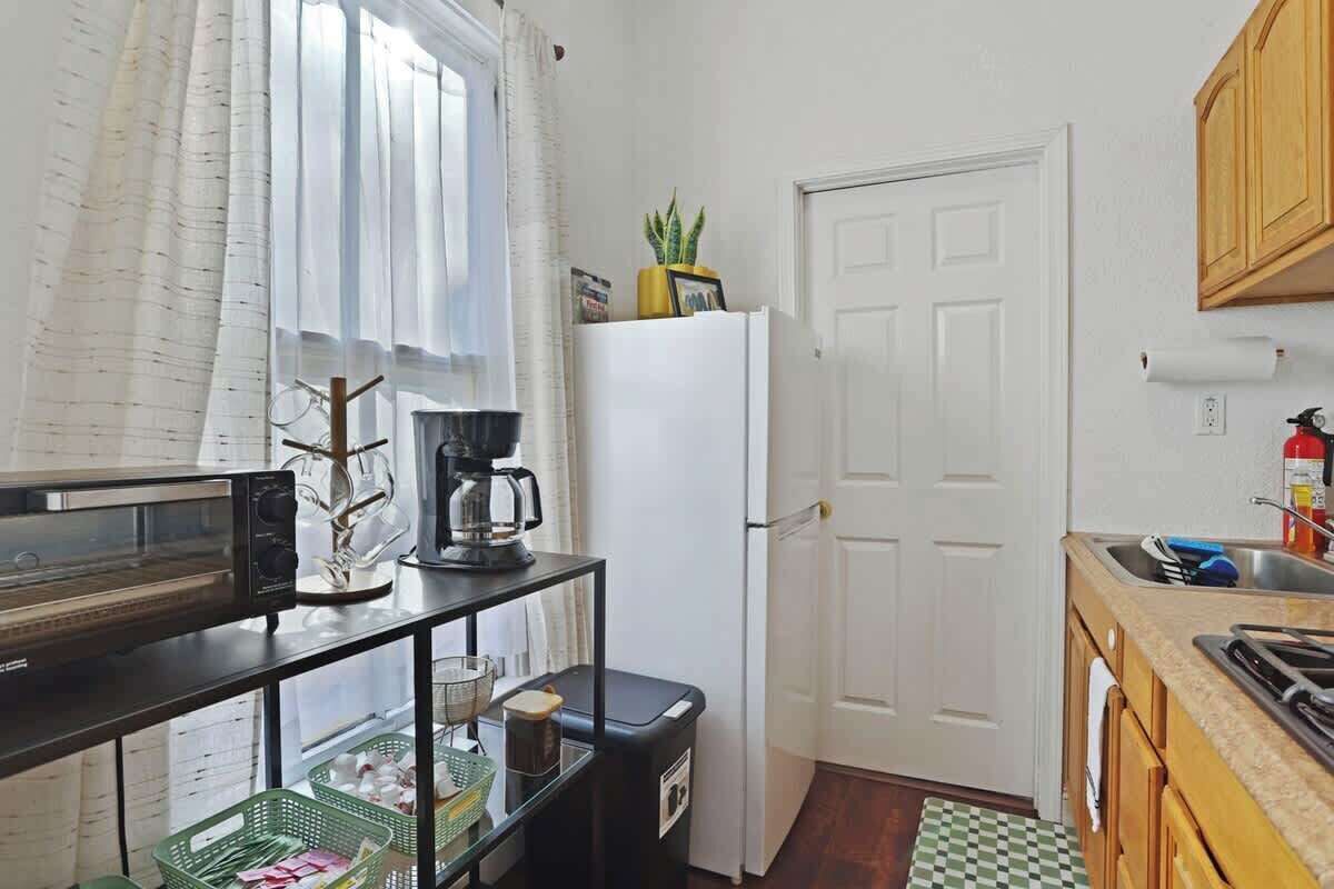 Fridge, microwave, coffee/tea maker, cookware/dishes/utensils