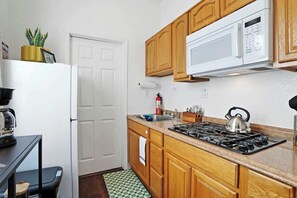 Fridge, microwave, coffee/tea maker, cookware/dishes/utensils