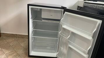 An open refrigerator with multiple shelves and a freezer compartment.