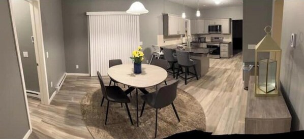 Enjoy meals in the dining area with a round table and comfortable chairs.
