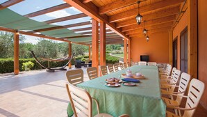 A covered outdoor dining area with a long table, chairs, and a hammock. - Country House Abate Pool Ac Wifi Potenza (Trivigno)
