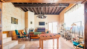 A cozy living room with a foosball table, comfortable seating, and a fireplace. - Gite "La maison de la colline" 5 minutes de Tournus Sud Bourgogne (Vers)