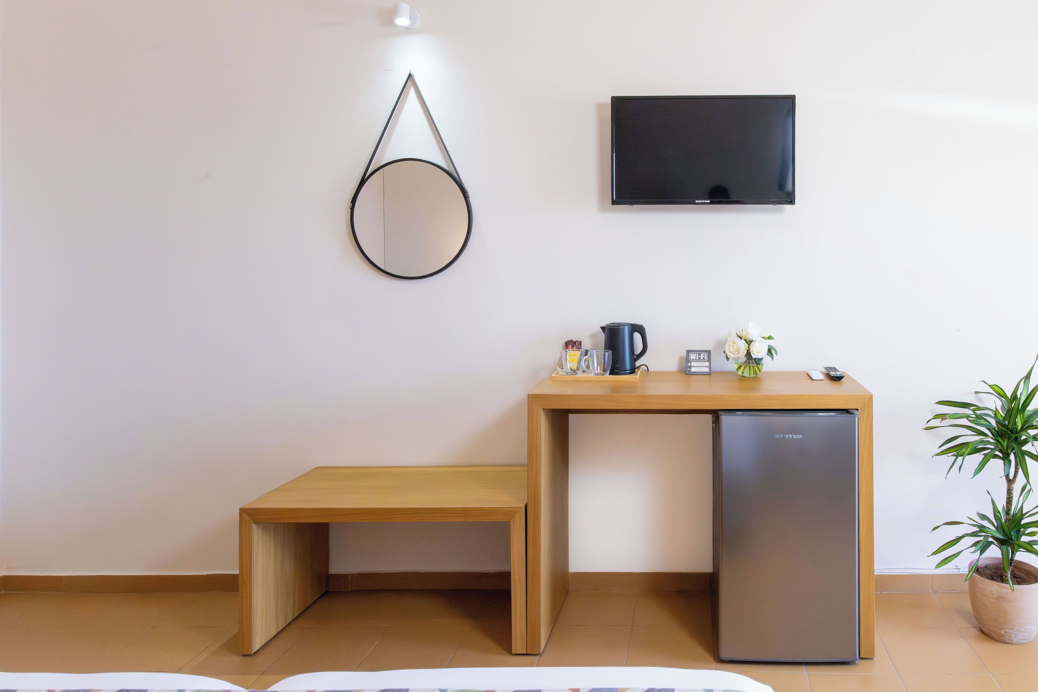 A small kitchenette with a refrigerator, a coffee maker, and a microwave.