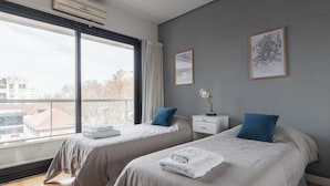 A hotel room with two beds, a large window, and a city view. - MOT LIVE HOTEL (Buenos Aires)