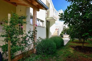 Stylish building with a balcony and landscaped garden.
