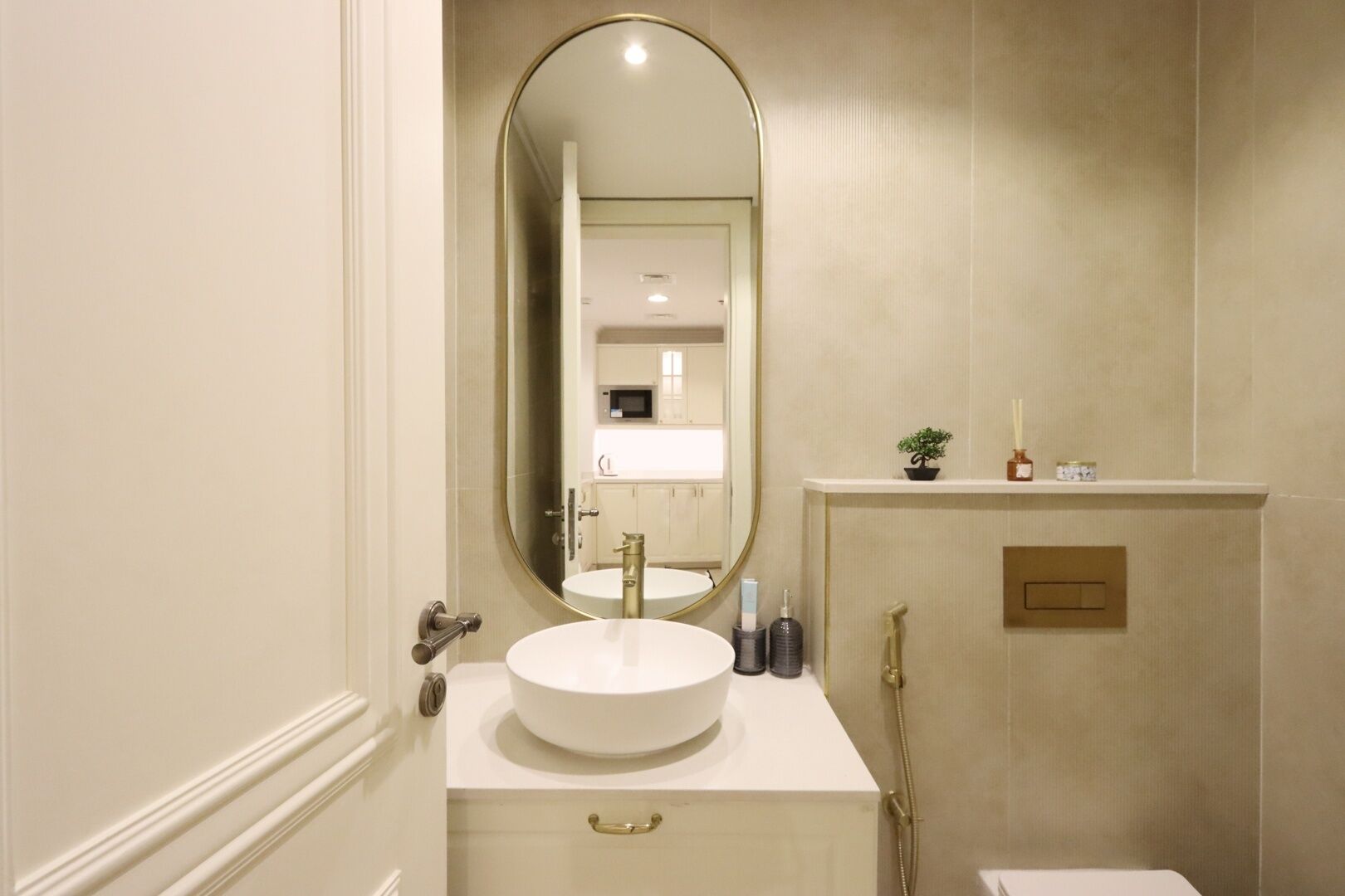 Une salle de bain avec un lavabo blanc, un grand miroir et une douche.