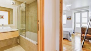 A bathroom with a glass-enclosed shower, a sink, and a mirror. - Quiet Prince - City Center Apartment (2D) (Lisboa)