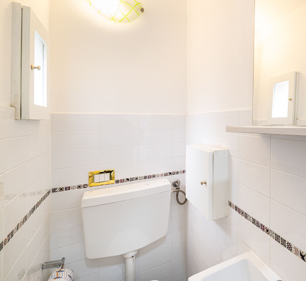 A bathroom with a white toilet, a sink, and a bathtub.