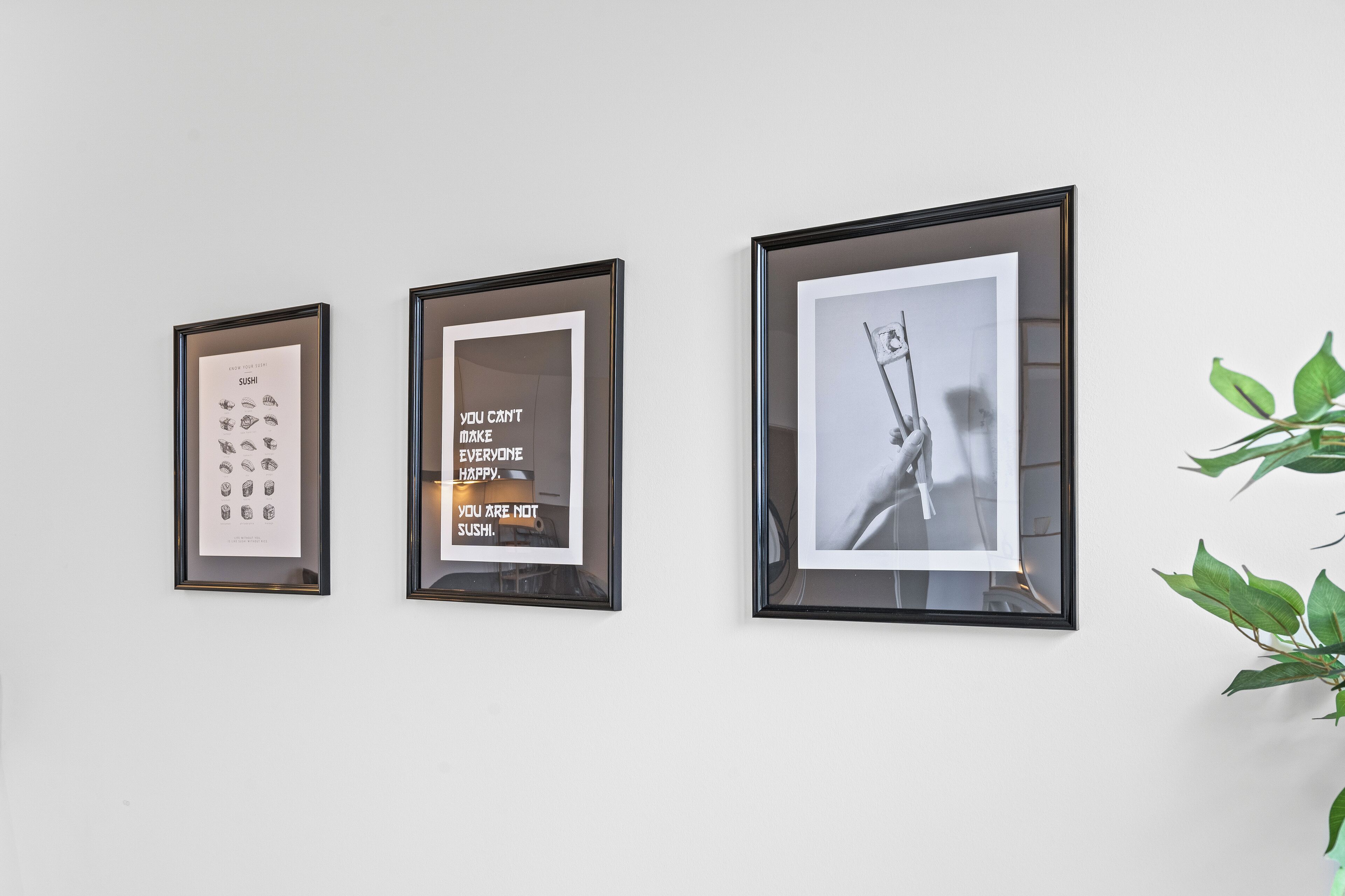 Three framed pictures on a wall.