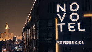 A building with illuminated signage reading "NOVOTEL RESIDENCES". - Novotel Residences Makkah (Makkah)