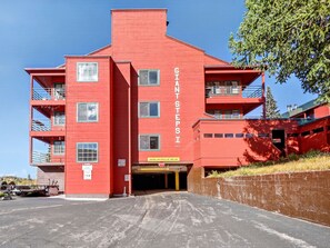 A red building with multiple balconies and a sign reading 'GIANT STEPS'.