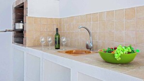 A kitchen with a built-in oven, a sink, and a bowl of fruit on the counter. - Villa Dolores - Three Bedroom Villa, Sleeps 6 (Puerto del Carmen)