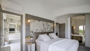 A modern bedroom with a large bed, a marble headboard, and a view of the balcony.