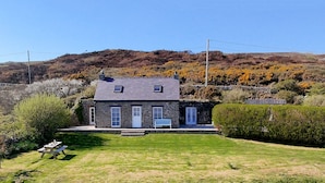 A stone house with a sloped roof, a small front porch, and a well-maintained lawn. - Talarfor - Two Bedroom Cottage, Sleeps 4 (Rhiw)