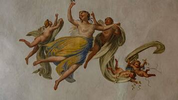 A classical fresco with figures in dynamic poses, suggesting movement and interaction.
