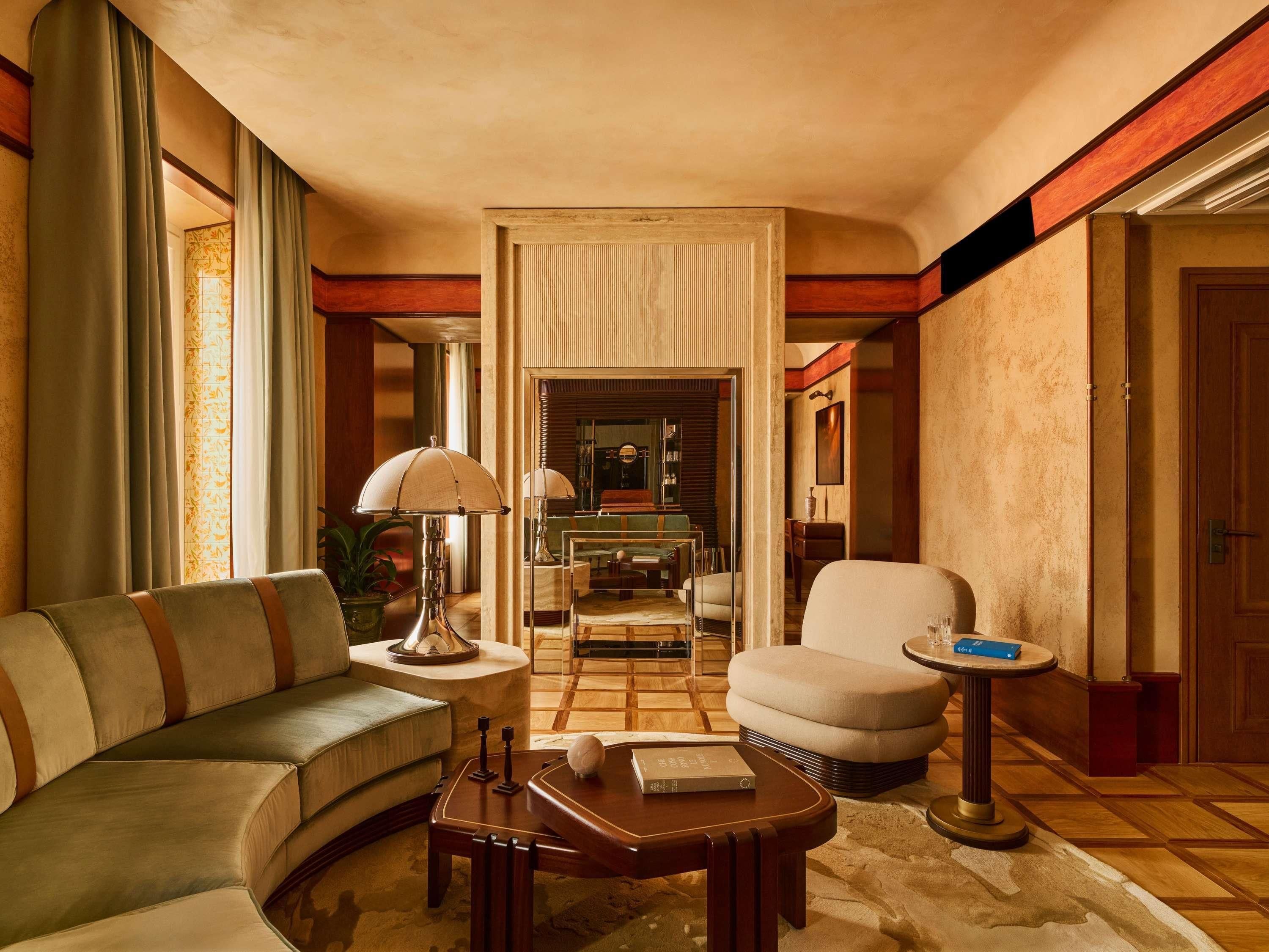 A well-appointed living room with a sofa, armchair, coffee table, and a side table with a lamp.