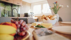A dining table with food items and a remote control.