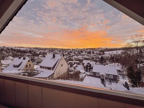 A snowy residential area with houses and a clear sky.