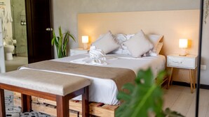 A neatly arranged bedroom with a bed, bedside tables, and a bench. - House of Turri: Suite | Views | Terrace | Jacuzzi (Turrialba)