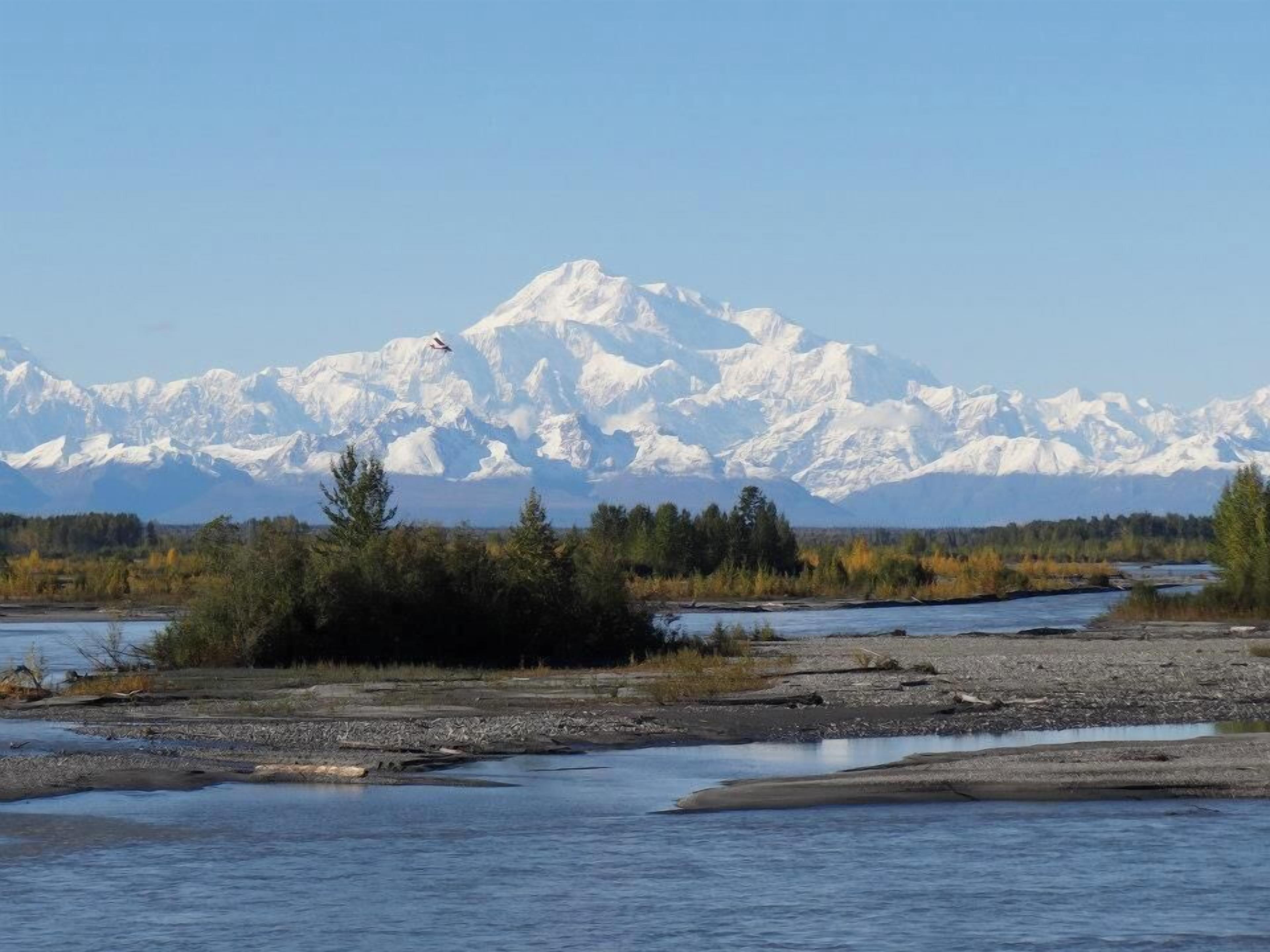 A river with a mountain range in the background.