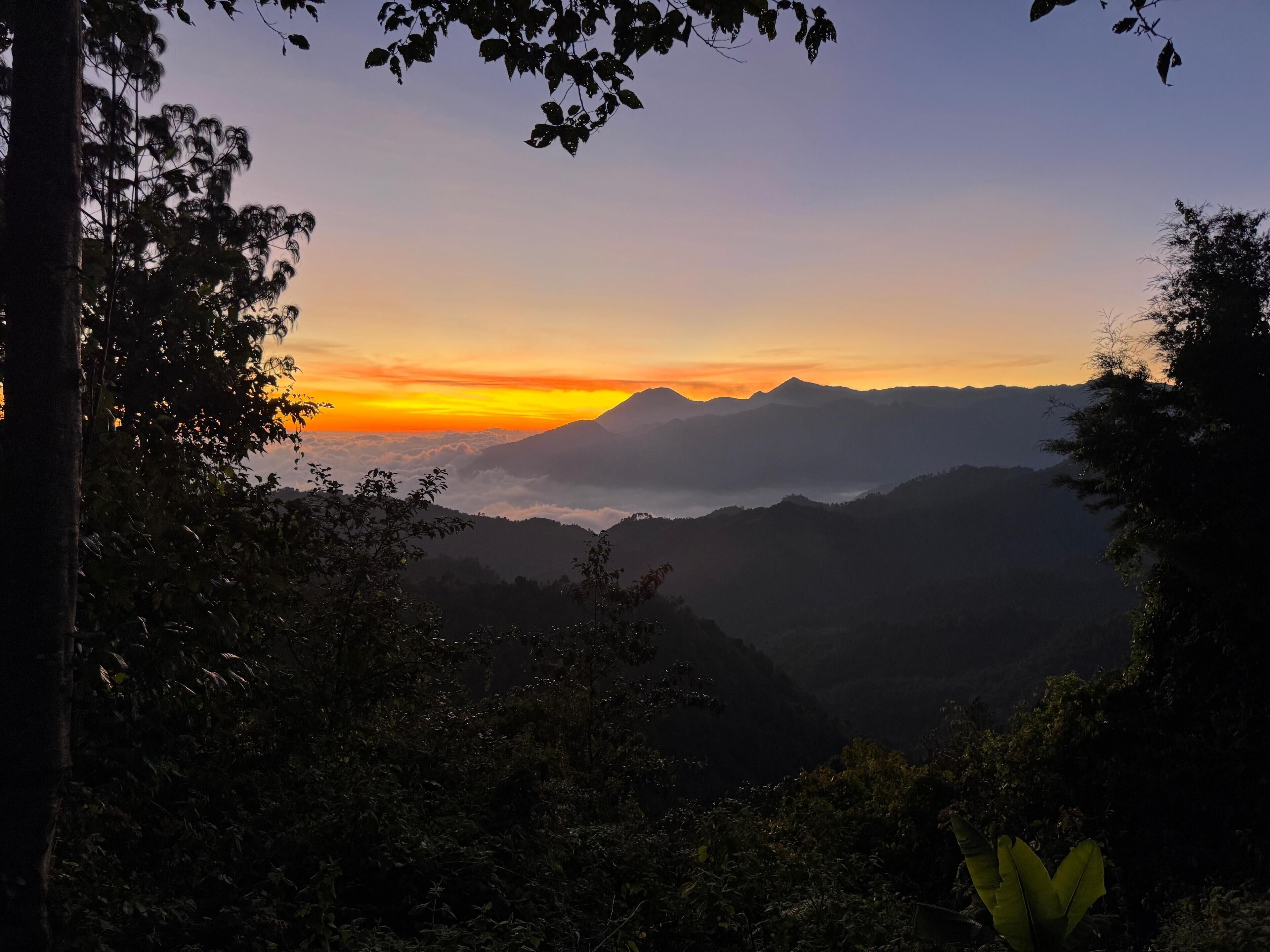 A mountainous landscape with a sunset.