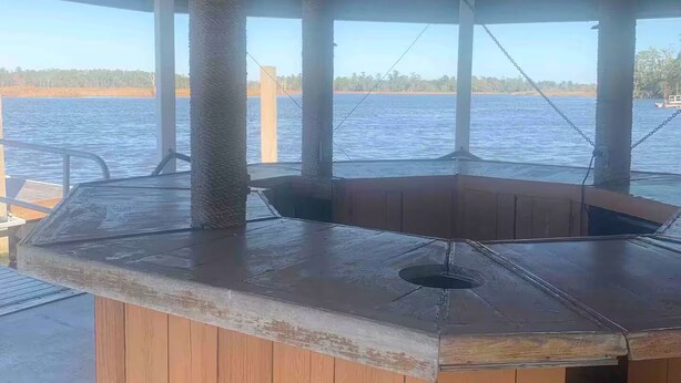 A wooden bar area with a view of the water. - Maggie Jo’s paradise on the river ! (Georgetown)