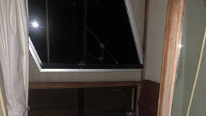 A small, compact bathroom with a toilet, sink, and window. - Take a break in nature (Georgetown)