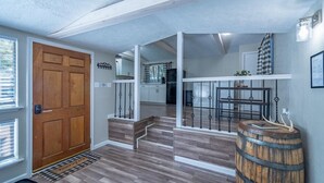 A modern kitchen with white cabinets, a black refrigerator, and a wooden countertop. - Serenity Hideaway, Charming 2bd/1ba cabin with WiFi, AC, close to shops (Ruidoso)