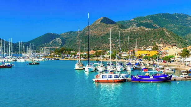 A marina with numerous boats docked, surrounded by houses and mountains in the background. - Rigilis - Two Bedroom Villa, Sleeps 4 (Nydri)