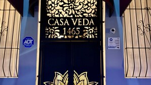 A building facade with a large, ornate door labeled 'CASA VEDA 1465.'