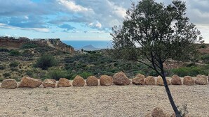 A rocky landscape with a solitary tree, a clear sky, and distant hills. - Las Cuevas - 3 bed finca in a serene setting (CN)