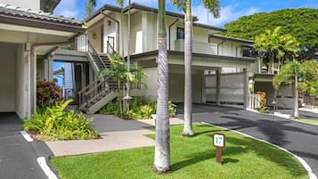A two-story building with a covered driveway and a number 17 sign.