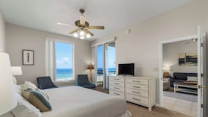 A bedroom with a bed, a TV, a desk, and a chair. - Ocean Views | Private Beach | Pool | Hot Tub | Sauna (Pensacola)