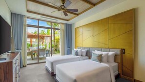 A hotel room with two beds, a desk, and a large window with a view of palm trees.