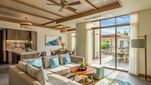 A spacious living room with a sofa, coffee table, and a dining area with a table and chairs. - Luxe 5 Star Villa Private Pool Resort Access (Da Nang)