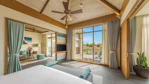 A hotel room with a large bed, a ceiling fan, a TV, and a balcony with curtains. - Luxe 5 Star Villa Private Pool Resort Access (Da Nang)