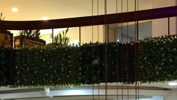A hotel lobby with a modern design, featuring a reception desk, a seating area with a wooden bench, and a decorative hanging light fixture. - Cartagena apartment facing the sea for four guests (Cartagena)