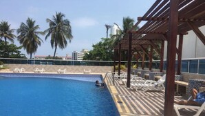 A swimming pool with lounge chairs and a pergola. - Cartagena apartment facing the sea for four guests (Cartagena)
